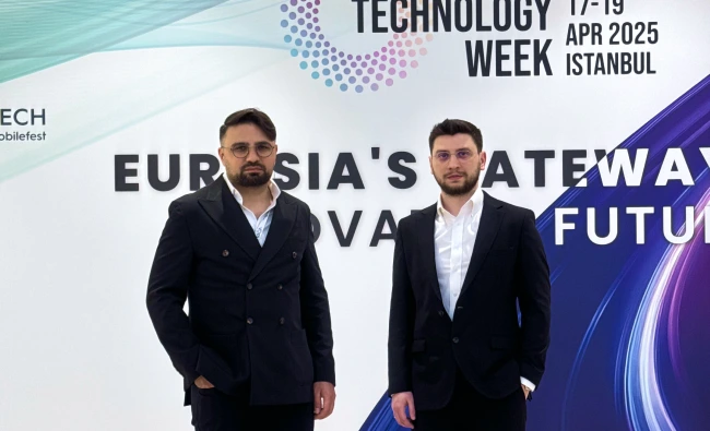Two VOYA representatives posing together in front of an event backdrop